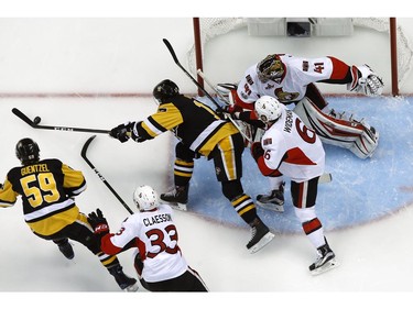 The Pittsburgh Penguins' Bryan Rust can't get to a rebound off Ottawa Senators goalie Craig Anderson.