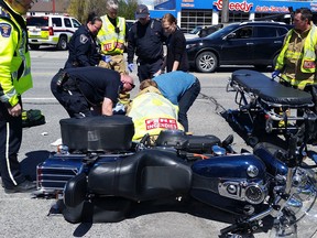 First responders work on a man seriously injured in a motorcycle crash in Orléans Wednesday morning.
