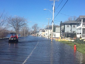 Gatineau police use an ATV to patrol the inundated streets of Pointe Gatineau Thursday.