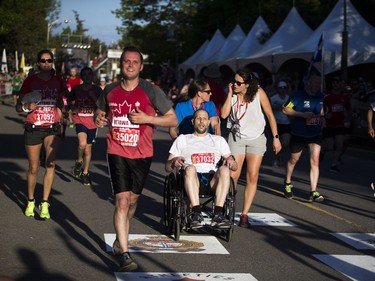 Carl Furney gets medical attention right before the finish line of the 10K race.