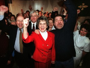 Celebrating doctors, nurses, volunteers and staff surround, from centre left, Gerald Savoie, President and Executive Director of Montfort, head legal council Ronald Caza (behind), President of SOS Montfort Gisèle Lalonde (in red) and Michel Gratton, Public Relations for Montfort Hospital as the province announces, in 2002, that it will not appeal court rulings that kept the hospital open.