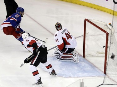 New York Rangers' Chris Kreider (20) shoots the puck past Ottawa Senators goalie Craig Anderson (41) for a goal as Cody Ceci (5) watches during the third period of Game 6 of an NHL hockey Stanley Cup second-round playoff series Tuesday, May 9, 2017, in New York. The Senators won 4-2.