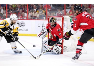 Chris Kunitz, left, misses a chance to score on Craig Anderson with Marc Methot blocking his stick in the second period.