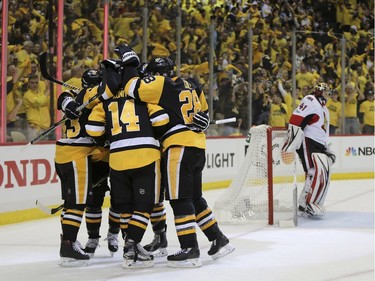 Pittsburgh Penguins left wing Chris Kunitz (14) celebrates with teammates after scoring a goal against the Ottawa Senators during the first period of Game 7 in the NHL hockey Stanley Cup Eastern Conference finals, Thursday, May 25, 2017, in Pittsburgh.
