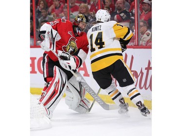 Craig Anderson clears the puck from Chris Kunitz in the second period.
