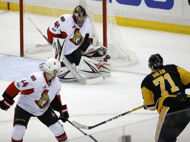 Ottawa Senators goalie Craig Anderson (41) blocks a shot by Pittsburgh Penguins' Evgeni Malkin (71) as the Senators' Jean-Gabriel Pageau (44) watches during the first period of Game 7 of the Eastern Conference final in the NHL Stanley Cup hockey playoffs in Pittsburgh, Thursday, May 25, 2017.