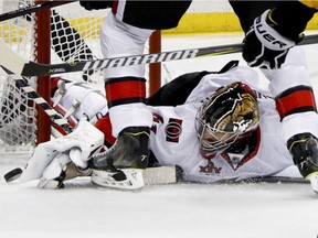 Ottawa Senators goalie Craig Anderson (41) knocks the puck out of the crease against the Pittsburgh Penguins during the second period of Game 2 of the Eastern Conference final in the NHL hockey Stanley Cup playoffs, Monday, May 15, 2017, in Pittsburgh.