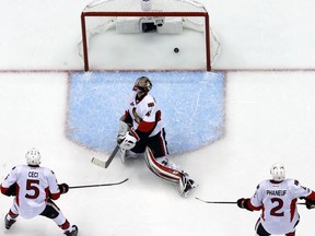 Ottawa Senators goalie Craig Anderson, center, reacts to allowing the game-winning goal by Pittsburgh Penguins' Phil Kessel during the third period of Game 2 of the Eastern Conference final in the NHL Stanley Cup hockey playoffs in Pittsburgh, Monday, May 15, 2017. The Penguins won 1-0.