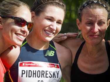 Dayna Pidhoresky (centre) was the top Canadian female finisher in the marathon Sunday May 28, 2017 at the Tamarack Ottawa Race Weekend. Pidhoresky was greeted by friends and fellow racers including L-R Natasha Wodak and Catherine Watkins after she finished.