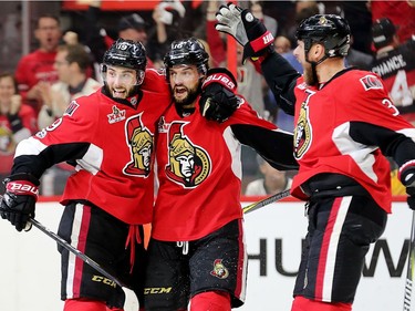 Derik Brassard (L) and Clarke MacArthur celebrate as Marc Methot joins them in the first period as the Ottawa Senators take on the Pittsburgh Penguins in Game 3 of the NHL Eastern Conference Finals at the Canadian Tire Centre.  Wayne Cuddington/Postmedia
