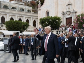 President Donald Trump waves as he takes a walking tour during the G7 Summit, Friday, May 26, 2017, in Taormina, Italy.