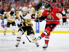 Erik Karlsson clears the puck with a soccer kick past Carl Hagelin in the second period of Game 3.