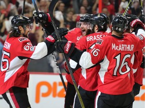 Erik Karlsson (L) joins his teammates including a happy Bobby Ryan (C) after the second goal of the game in the first period as the Ottawa Senators take on the Pittsburgh Penguins in Game 3 of the NHL Eastern Conference Finals at the Canadian Tire Centre.