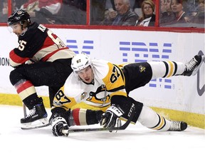 The Ottawa Senators' Erik Karlsson and the Pittsburgh Penguins' Sidney Crosby battle along the boards in a March 2017 game. On Karlsson, Crosby says, 'He's continually gotten better. You see the minutes that he consistently plays ... that's so difficult to do, especially when everybody knows that you're the guy with the puck, and they're trying to finish their hits.'