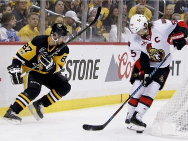 The Senators' Erik Karlsson kicks at the puck after getting it away from the Penguins' Sidney Crosby during the second period of Game 1 of the Eastern Conference final on Saturday, May 13, 2017, in Pittsburgh.