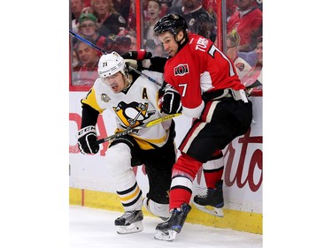 Evgeni Malkin and Kyle Turris battle along the boards in the third period.
