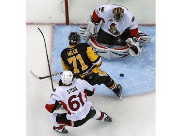 Ottawa Senators goalie Craig Anderson (41) stops a shot by Pittsburgh Penguins' Evgeni Malkin (71) during the first period of Game 2 of the Eastern Conference final with Mark Stone (61) defending in the NHL Stanley Cup hockey playoffs in Pittsburgh, Monday, May 15, 2017.(AP Photo/Gene J. Puskar) ORG XMIT: PAGP101