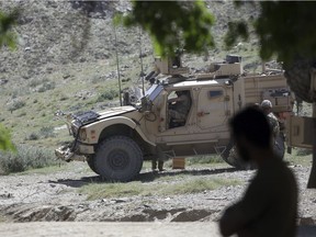 In this April 17, 2017 file photo, U.S. forces and Afghan commandos patrol in Asad Khil village near the site of a U.S. bombing in the Achin district of Jalalabad, east of Kabul, Afghanistan.