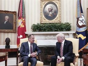 This May 10 photo, made available by the Russian Foreign Ministry, shows U.S. President Donald Trump (R) speaking with Russian Foreign Minister Sergei Lavrov during a meeting at the White House.