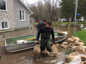 Chris Blenkiron has been hauling sandbags for three days to protect his house on Leo Lane in Cumberland. He takes a break when the bags run out.