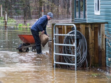 Gaby Brisson helps sandbag around Kim Brant's home as the residents of Constance Bay deal with the Ottawa River rising to record levels and  flooding the region.  a