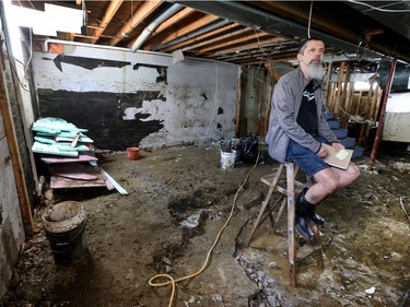 Frank Toutloff sits in the basement of his destroyed Rue Saint-Louis home in Gatineau Monday May 15, 2017. Water came up through his cement floor and destroyed his foundation and finished basement.