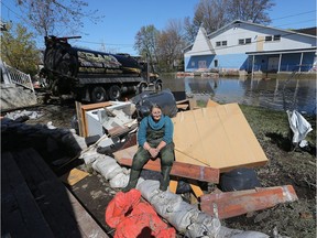 Diane Bourrée takes a rest on her belongings outside her Rue Saint-Louis house in Gatineau. Bourrée, 63, never thought she would ever be in this situation so close to retirement.