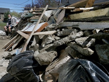 Frank Toutloff sits among the materials from his basement of his destroyed Rue Saint-Louis home in Gatineau Monday May 15, 2017. Water came up through his cement floor and destroyed his foundation and finished basement.