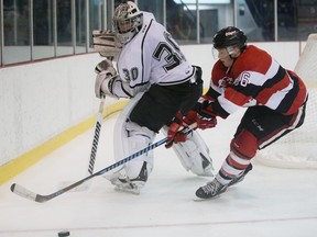 Olympiques goalie Mark Grametbauer moves the puck away from the 67's Drake Rymsha during a pre-season game at Gatineau's Robert Guertin Arena last September. Next time the two teams meet, it will be for regular-season points. Errol McGihon/Postmedia