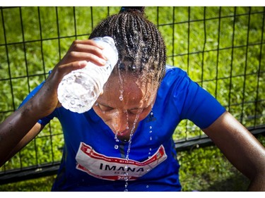 Guteni Imana was the top female finisher in the marathon Sunday May 28, 2017 at the Tamarack Ottawa Race Weekend. Imana pours cold water over her head to cool down after finishing the race.