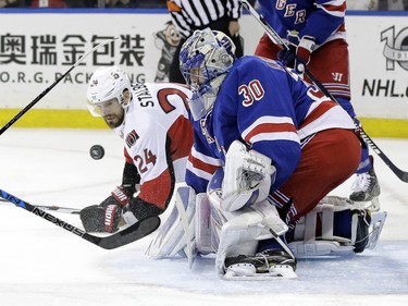 New York Rangers goalie Henrik Lundqvist (30), of Sweden, deflects a shot as Ottawa Senators' Viktor Stalberg (24) watches during the first period of Game 3 of an NHL hockey Stanley Cup second-round playoff series Tuesday, May 2, 2017, in New York.