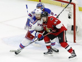 Ottawa Senators centre Jean-Gabriel Pageau (44) battles with New York Rangers defenceman Brendan Smith (42) in front of goalie Henrik Lundqvist (30) during the first overtime period in game two.