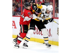 Jean-Gabriel Pageau checks Evgeni Malkin into the boards in the first period as the Ottawa Senators take on the Pittsburgh Penguins in Game 3 of the NHL Eastern Conference Finals at the Canadian Tire Centre.  Wayne Cuddington/Postmedia