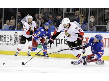 New York Rangers' Jimmy Vesey (26) vies for control of the puck with Ottawa Senators' Clarke MacArthur (16) during the first period of Game 3 of an NHL hockey Stanley Cup second-round playoff series Tuesday, May 2, 2017, in New York.