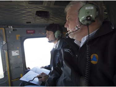 Canadian Prime Minister Justin Trudeau and Quebec Premier Philippe Couillard fly over areas affected by flooding in Gatineau, Que., Thursday, May 11, 2017.