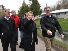 Premier Kathleen Wynne and Mayor Jim Watson survey flood damage in Cumberland earlier this week.