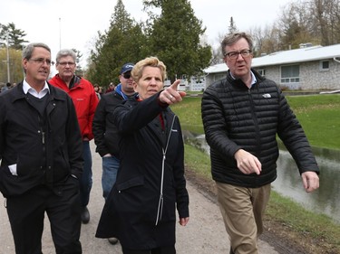 Kathleen Wynne and Jim Watson walk on Morin Road in Cumberland, May 08, 2017. The area was severely flooded by the Ottawa River.