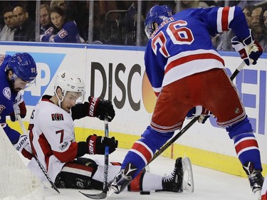 Ottawa Senators' Kyle Turris, center, fights for control of the puck with New York Rangers' Brady Skjei right, and Mika Zibanejad, left, during the first period of Game 4 of an NHL hockey Stanley Cup second-round playoff series Thursday, May 4, 2017, in New York.