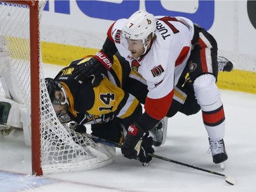 Ottawa Senators' Kyle Turris (7) checks Pittsburgh Penguins' Chris Kunitz (14) behind the net during the first period of Game 5 in the NHL hockey Stanley Cup Eastern Conference finals, Sunday, May 21, 2017, in Pittsburgh.