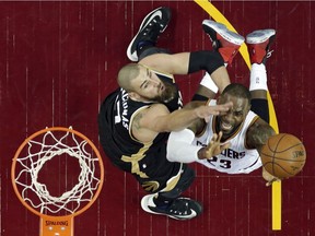 Toronto Raptors' Jonas Valanciunas, left, from Lithuania, defends Cleveland Cavaliers' LeBron James during the first half in Game 2 of a second-round NBA basketball playoff series, Wednesday, May 3, 2017, in Cleveland.