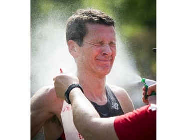 Louis-Philippe Garnier gets sprayed with cool water after finishing the marathon Sunday May 28, 2017 at the Tamarack Ottawa Race Weekend.