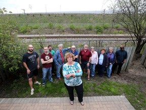 Neighbours from Eastway Gardens neighbourhood are upset about plans to remove the berm between the Via Rail track and the LRT yard behind it.