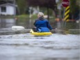 Madeleine Bastien paddles out so she can check the status of her home and pick up a few personal belongings. Water levels in Gatineau started to come down in the flooding but major damage is starting to show Saturday May 13, 2017.