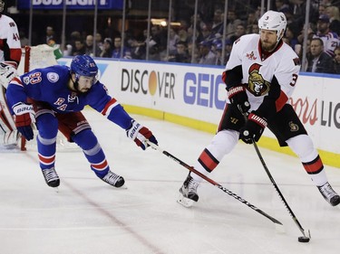 New York Rangers' Mika Zibanejad (93) fights for control of the puck with Ottawa Senators' Marc Methot (3) during the second period of Game 6 of an NHL hockey Stanley Cup second-round playoff series, Tuesday, May 9, 2017, in New York.