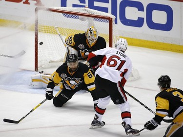 Ottawa Senators right wing Mark Stone (61) scores a goal against Pittsburgh Penguins defenseman Trevor Daley (6) and goalie Matt Murray (30) during the second period of Game 7 of the Eastern Conference final in the NHL Stanley Cup hockey playoffs in Pittsburgh, Thursday, May 25, 2017.