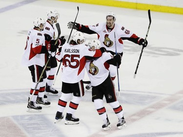 Ottawa Senators' Mark Stone (61) and Erik Karlsson (65) celebrate with teammates during the third period of Game 6 of an NHL hockey Stanley Cup second-round playoff series, Tuesday, May 9, 2017, in New York. The Senators won 4-2.