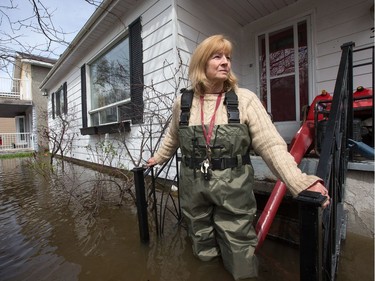 Mary Courneyea at her house on Rue Saint-Patrice in Gatineau which is now unreachable by car. She fears she will lose her house. She just put it up for sale in hopes of retiring to a very small bungalow, but now she fears she has lost everything.as flooding continues throughout the region in areas along the local rivers.  Wayne Cuddington/Postmedia