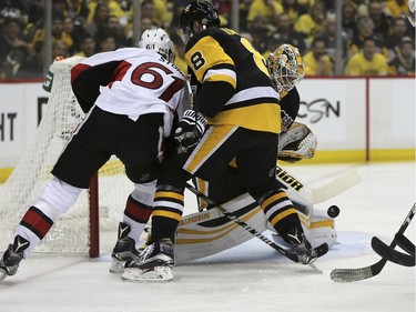 Pittsburgh Penguins goalie Matt Murray, right, blocks a shot by Ottawa Senators right wing Mark Stone (61) as Stone shoots against the Penguins defenseman Brian Dumoulin (8) during the first period of Game 7 in the NHL hockey Stanley Cup Eastern Conference finals, Thursday, May 25, 2017, in Pittsburgh.