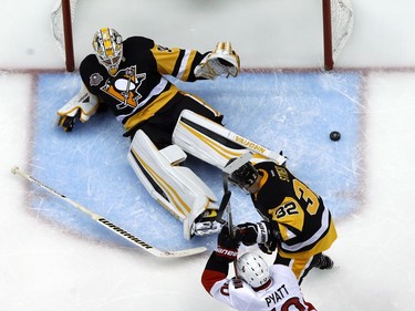 Pittsburgh Penguins goalie Matt Murray (30) sprawls across the goal crease as a shot goes wide of the net with Penguins' Mark Streit (32) defending Ottawa Senators' Tom Pyatt (10) during the second period of Game 5 of the Eastern Conference final in the NHL Stanley Cup hockey playoffs in Pittsburgh, Sunday, May 21, 2017. The Penguins won 7-0.