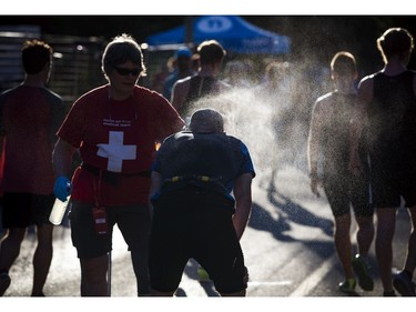 The medical team sprays racers with a mist of water after the runners had crossed the 10K finish line.